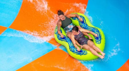 Girls riding Coastline Plunge Vortex water slide