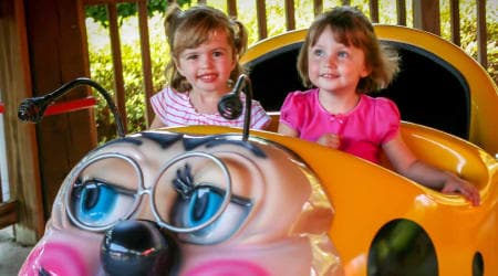 2 adorable littler girls riding the granny bug ride at Hersheypark