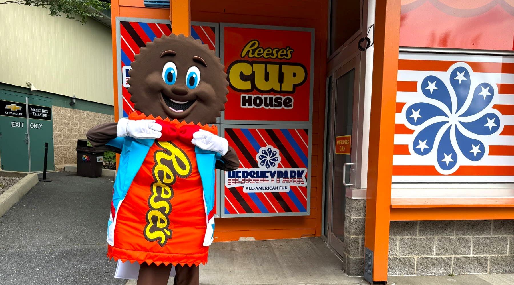 Reese Character in front of Reese's Cup House attraction.