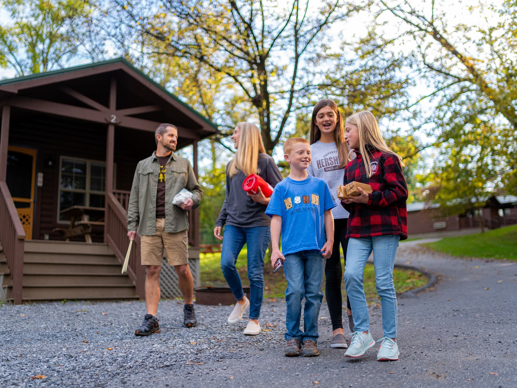family_outside_cabin_camping.jpg
