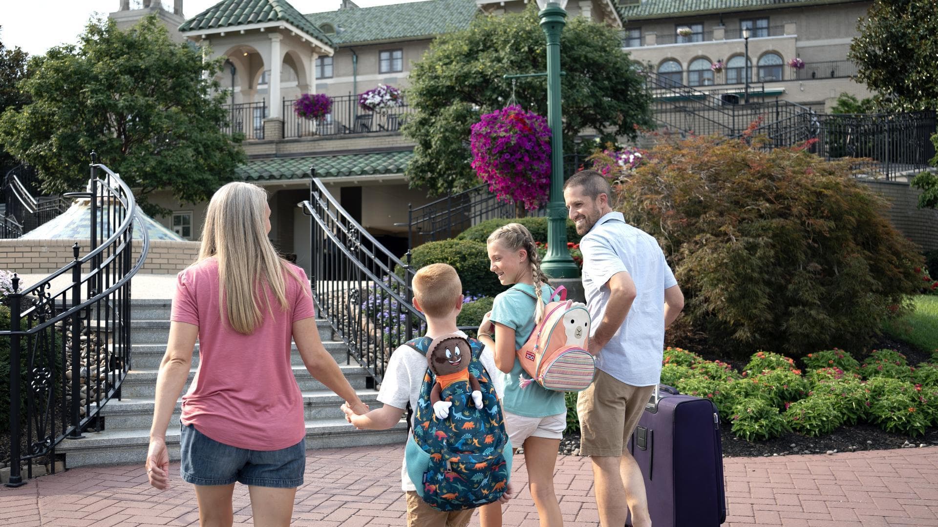 family-carrying-luggage-to-hotel-hershey.jpg