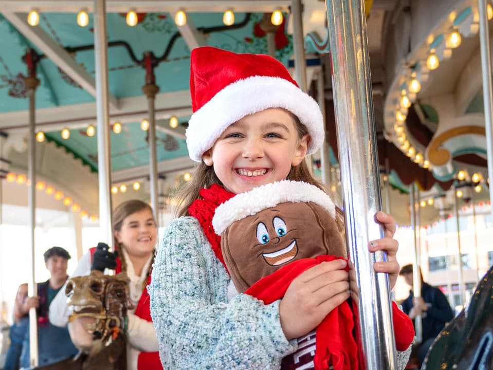 Girl-Riding-Carrousel-At-Christmas.jpg