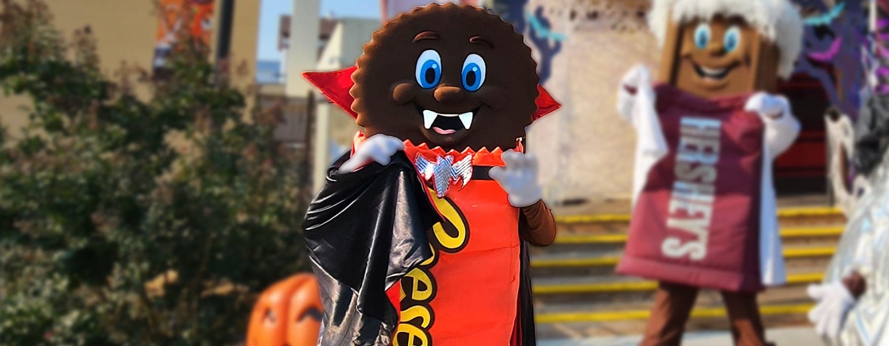 Life sized Reese's Peanut Butter Cup character smiling for picture with children